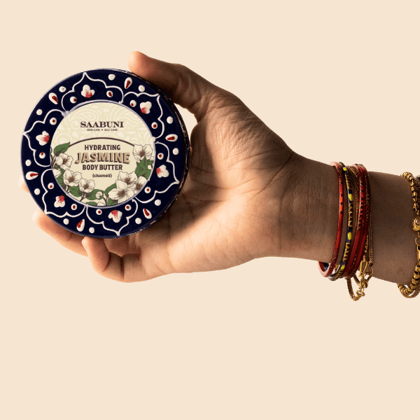 Holding a Jasmine body butter tin