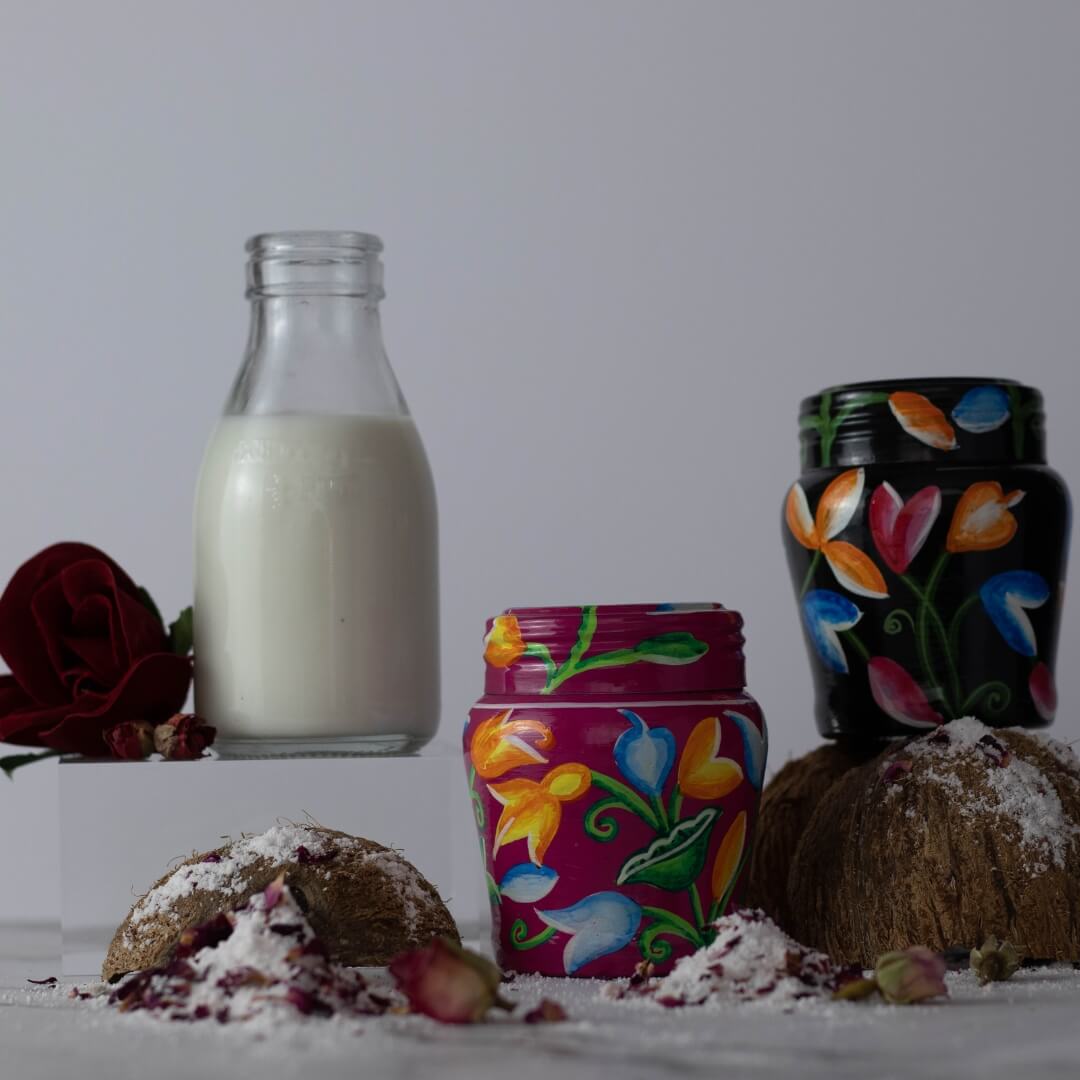 Coconuts milk and images of a black and pink tin with bath milk inside