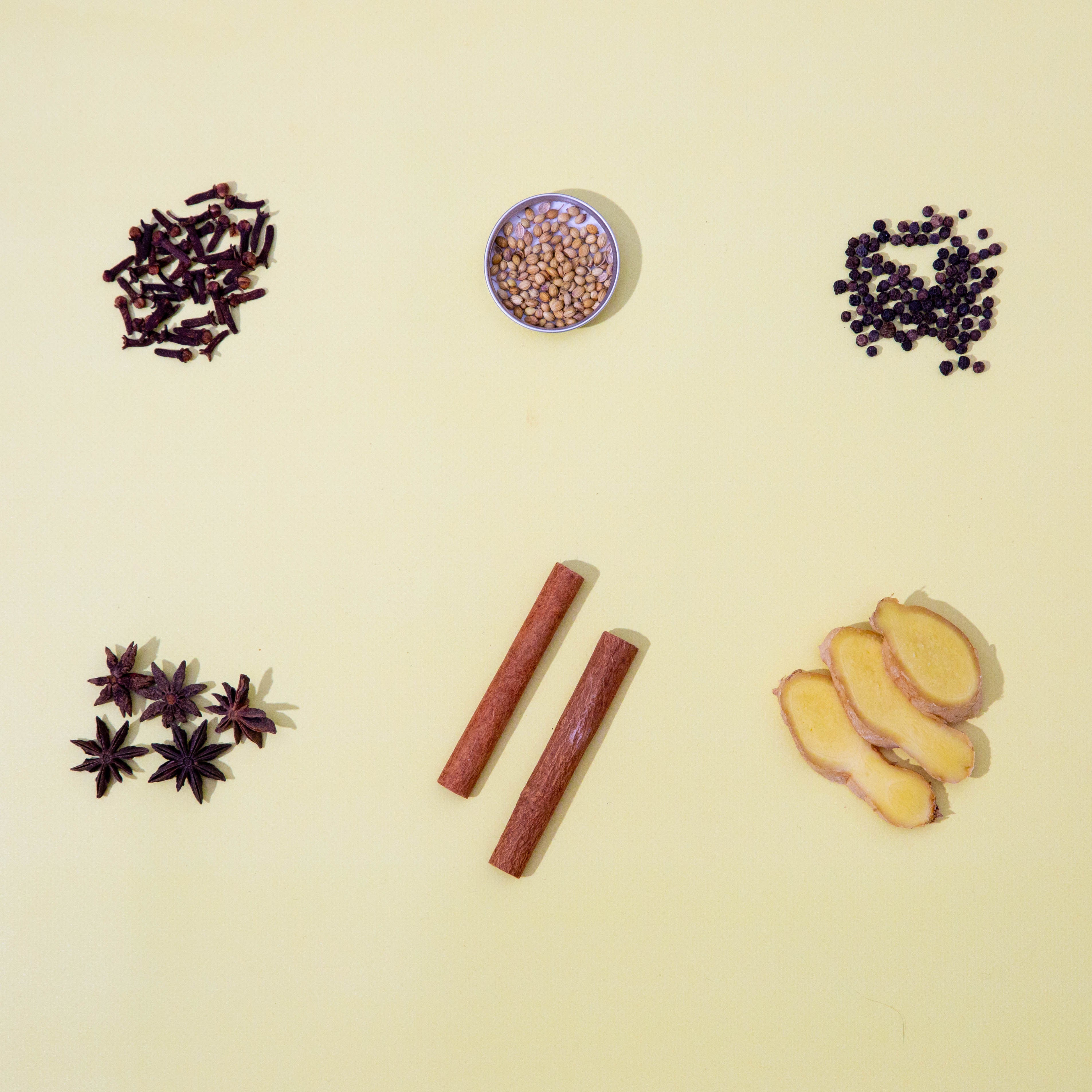 six spices on yellow background