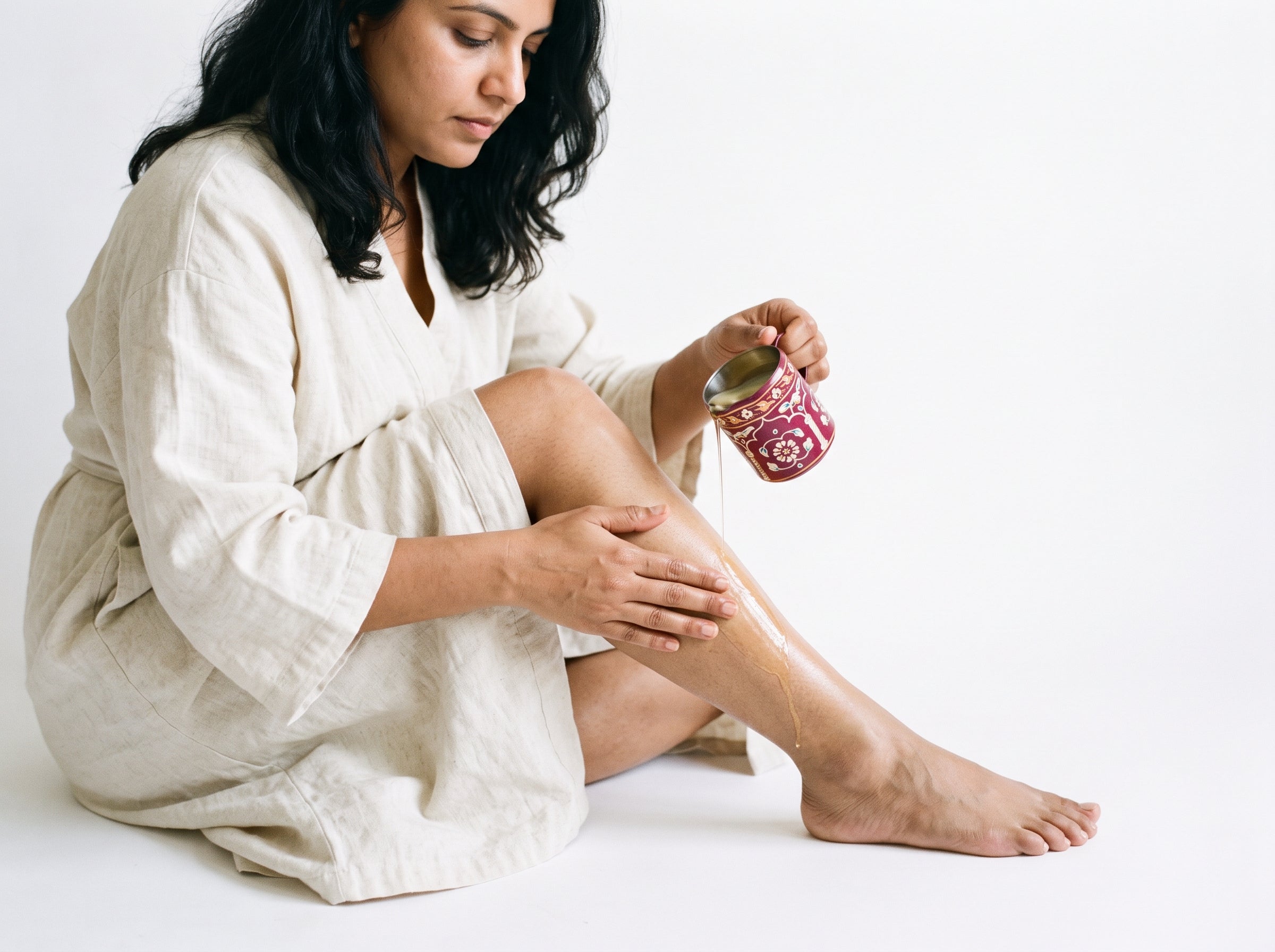 Woman applying massage candle oil