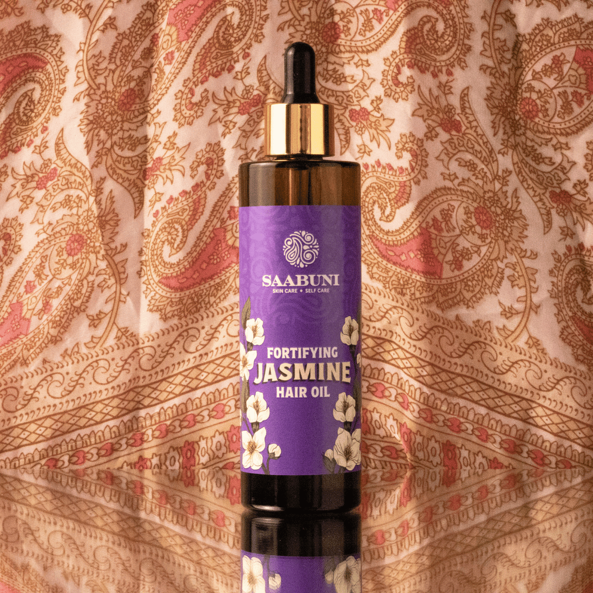 Saabuni Jasmine hair oil with paisley background