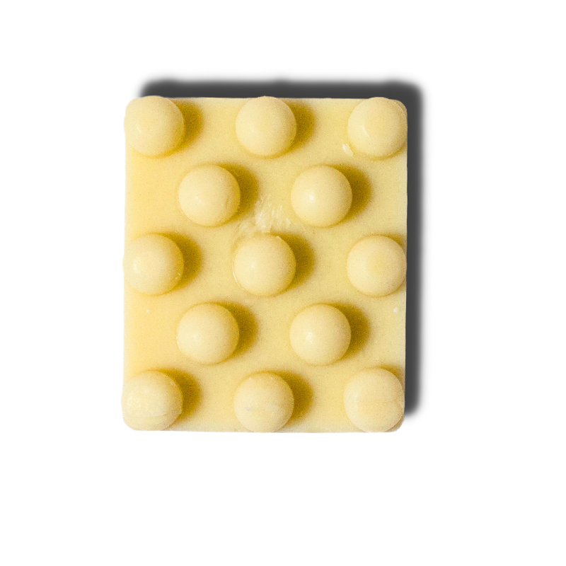 Rectangular bar of soap with raised circular nodules on a white background