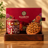 SAABUNI gift set displayed in a wooden tray, featuring a red floral-patterned mug with a lid, a wooden scalp massager with brass tines, and the red branded gift box behind it.