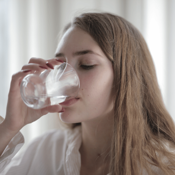 woman drinking water from a glass