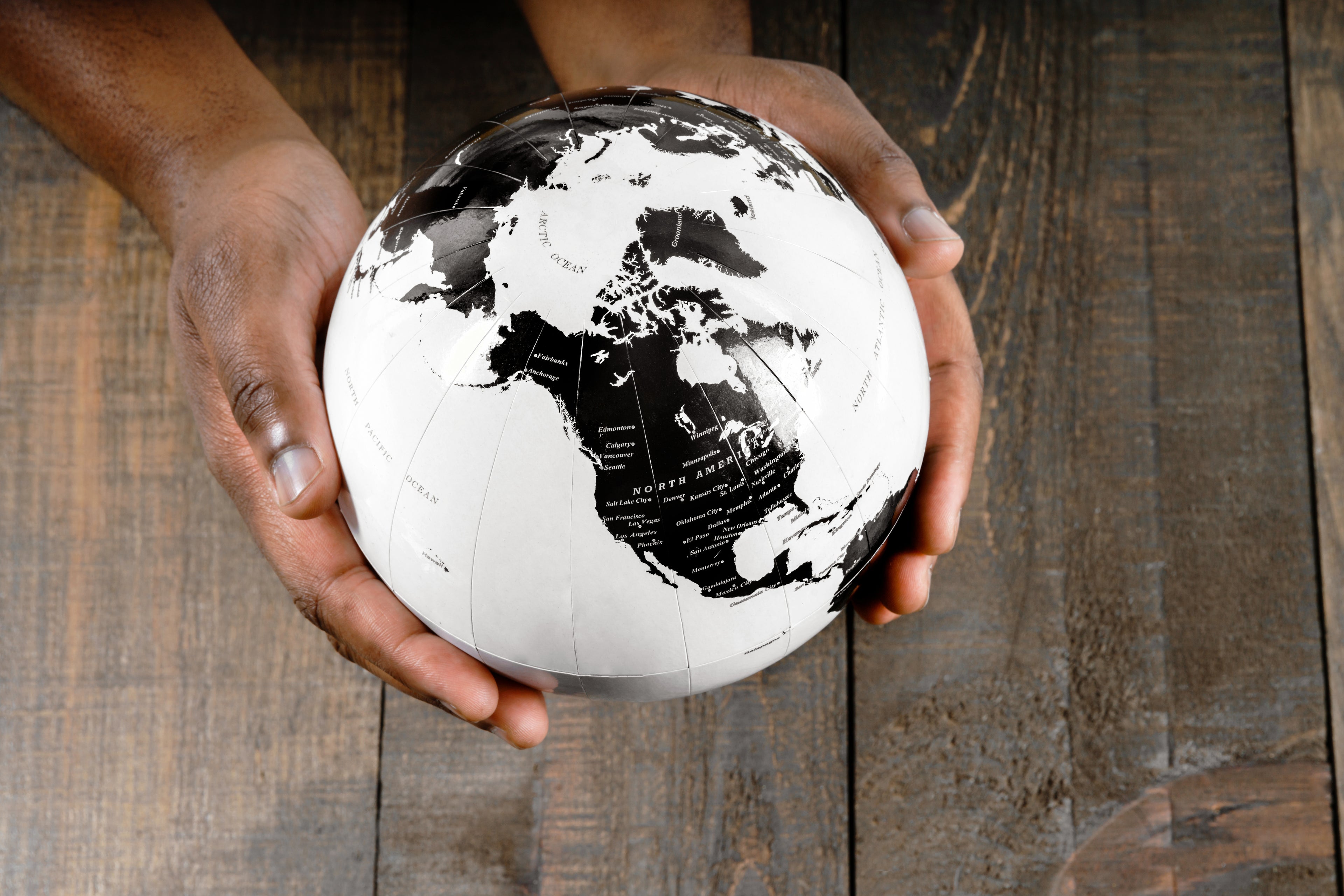 a photo of a globe in someone's hands