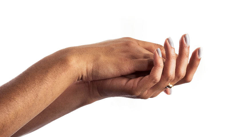 hands with white nails rubbing together