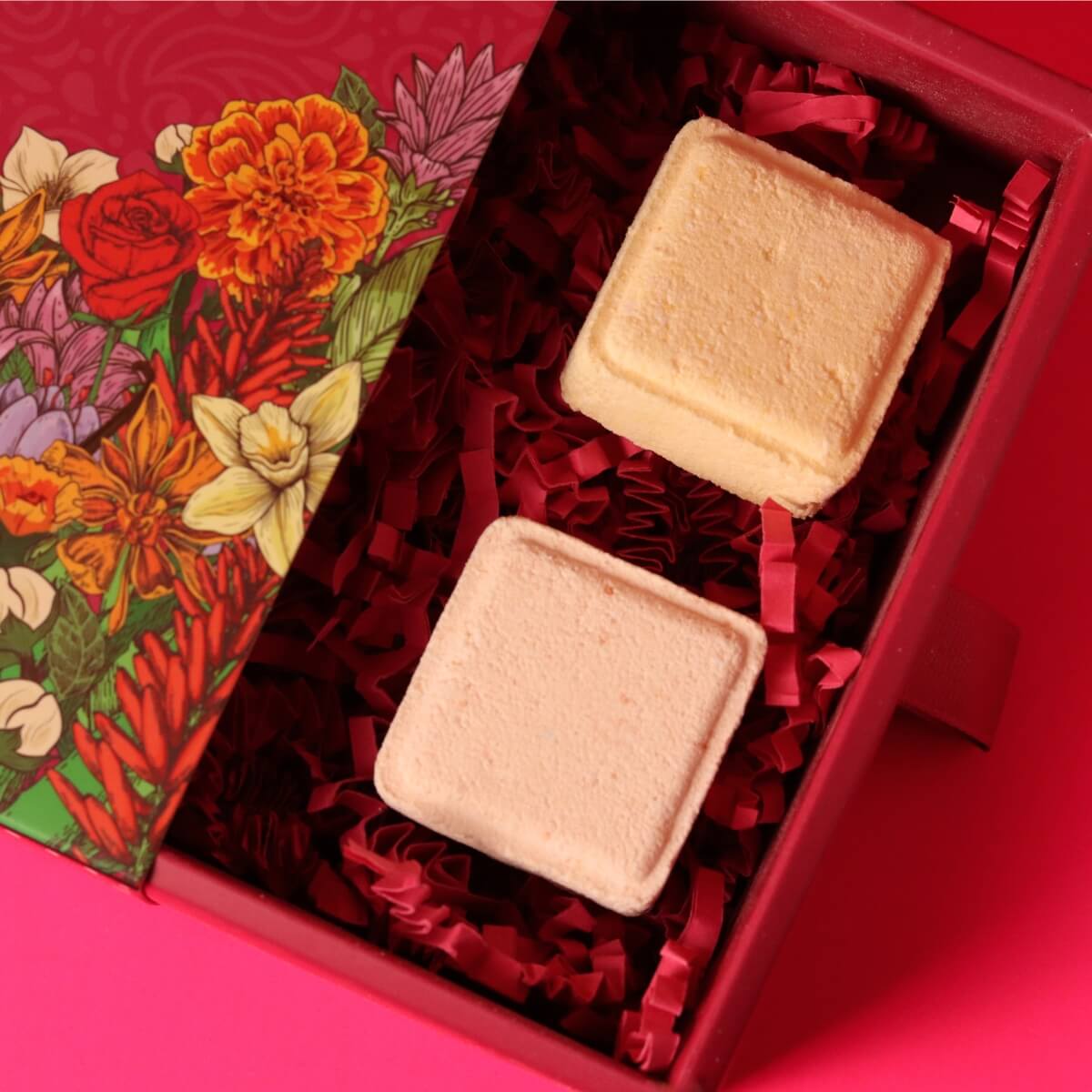 Two square shower melts in a decorative box with floral design
