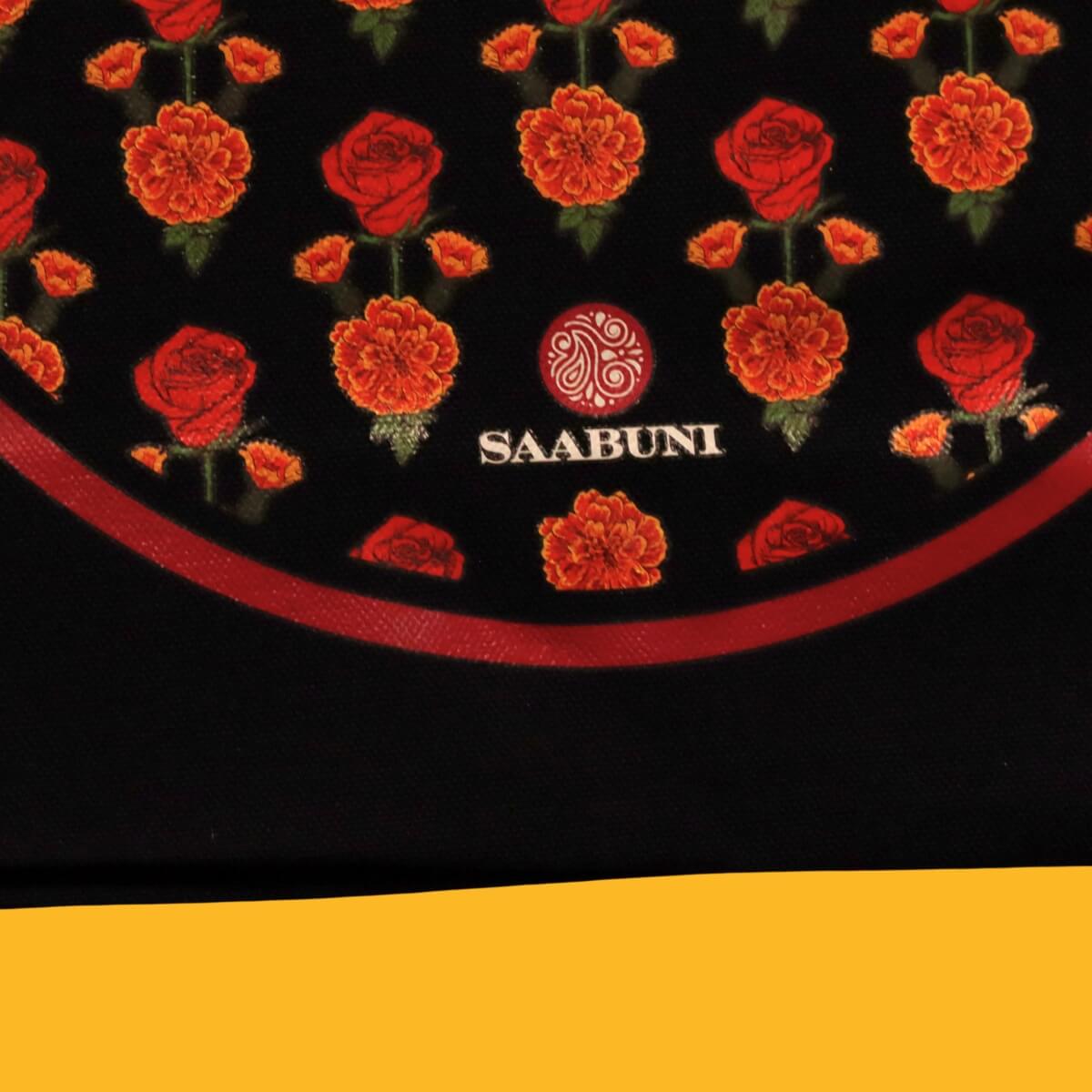 Black circular mat with red floral patterns and 'SAABUNI' logo